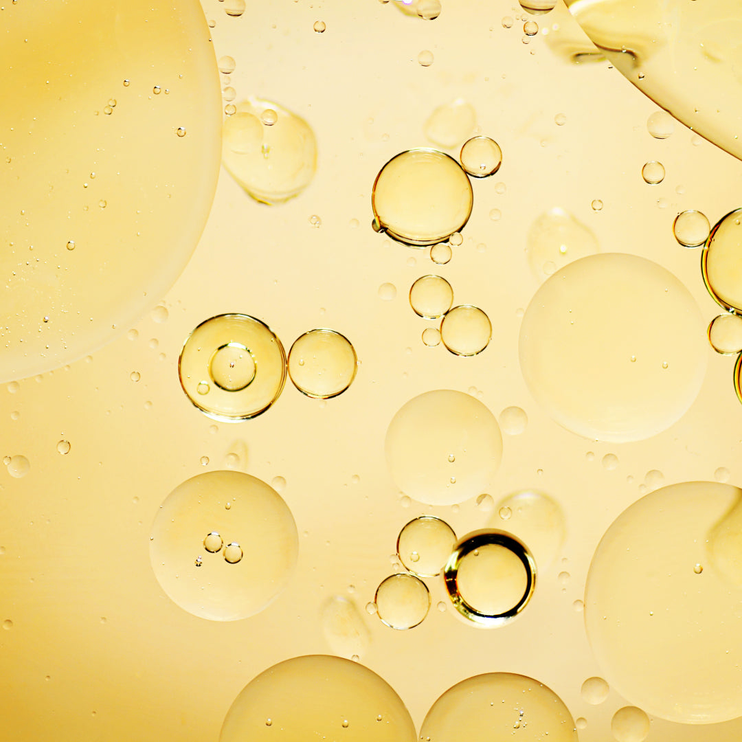 Argan oil, a yellow oily liquid with bubbles.