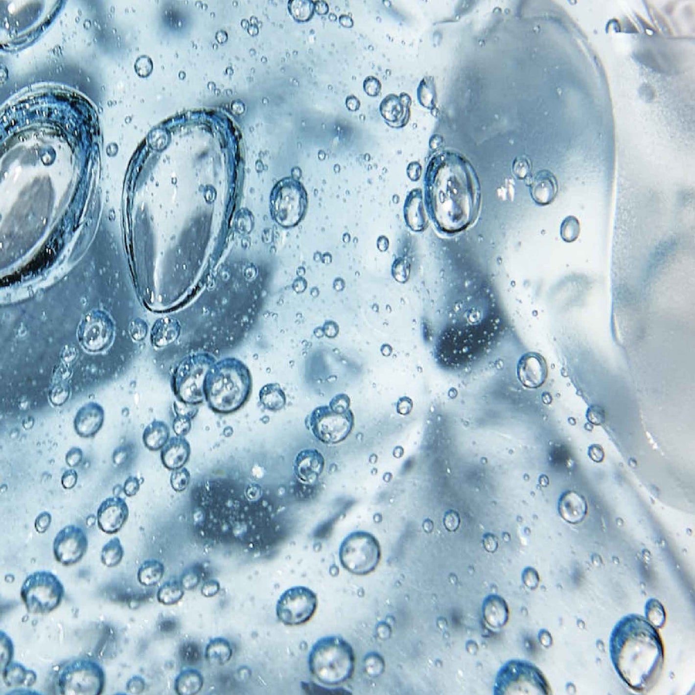 Close up of the blue translucent liquid of the skincare ingredient, fermented hyaluronic acid