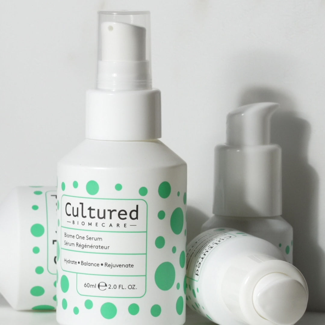 A video close up bottle of Cultured Biome One Serum and it's matte white liquid content.